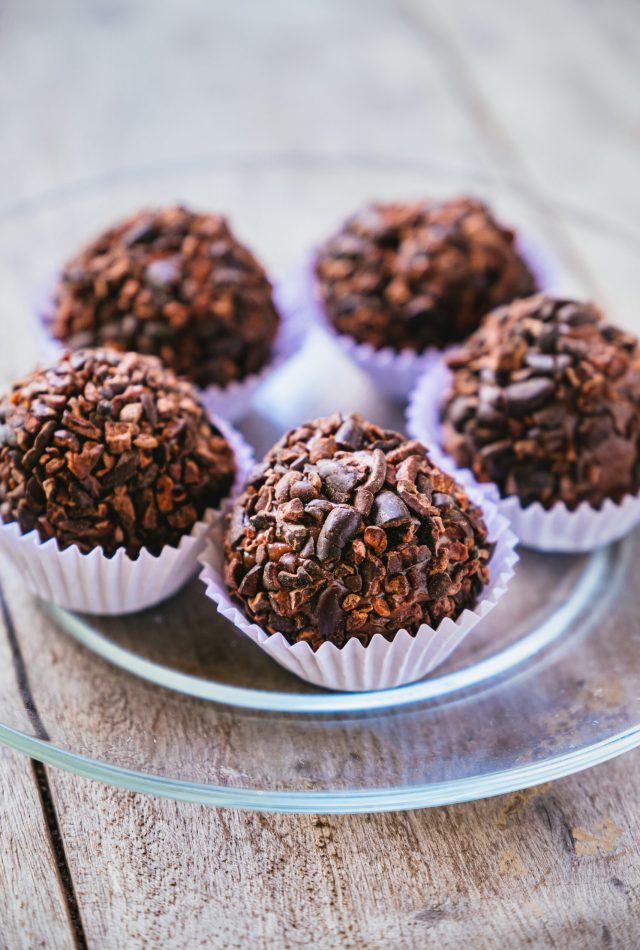 A vertical closeup shot of chocolate cupcakes on a plate
